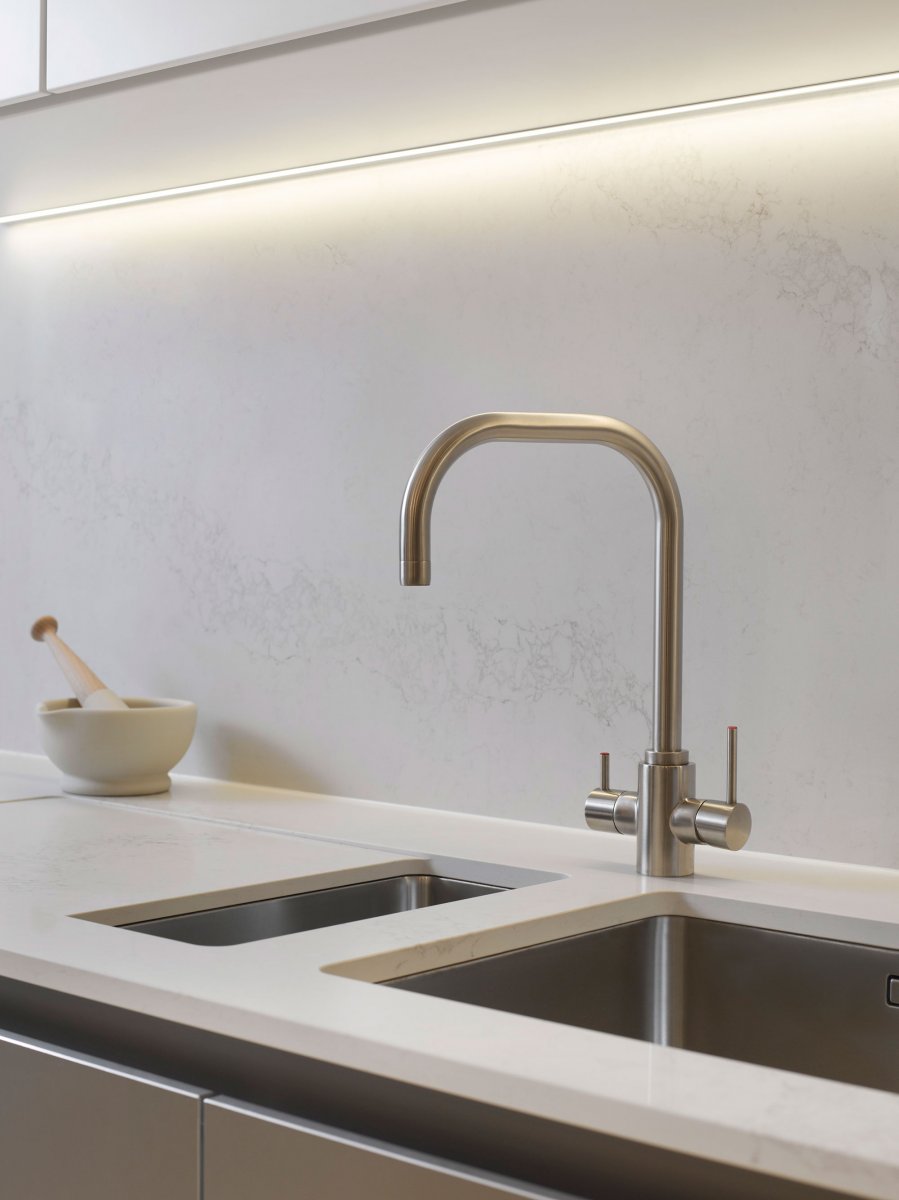 Brushed steel taps and marble splashback in the kitchen