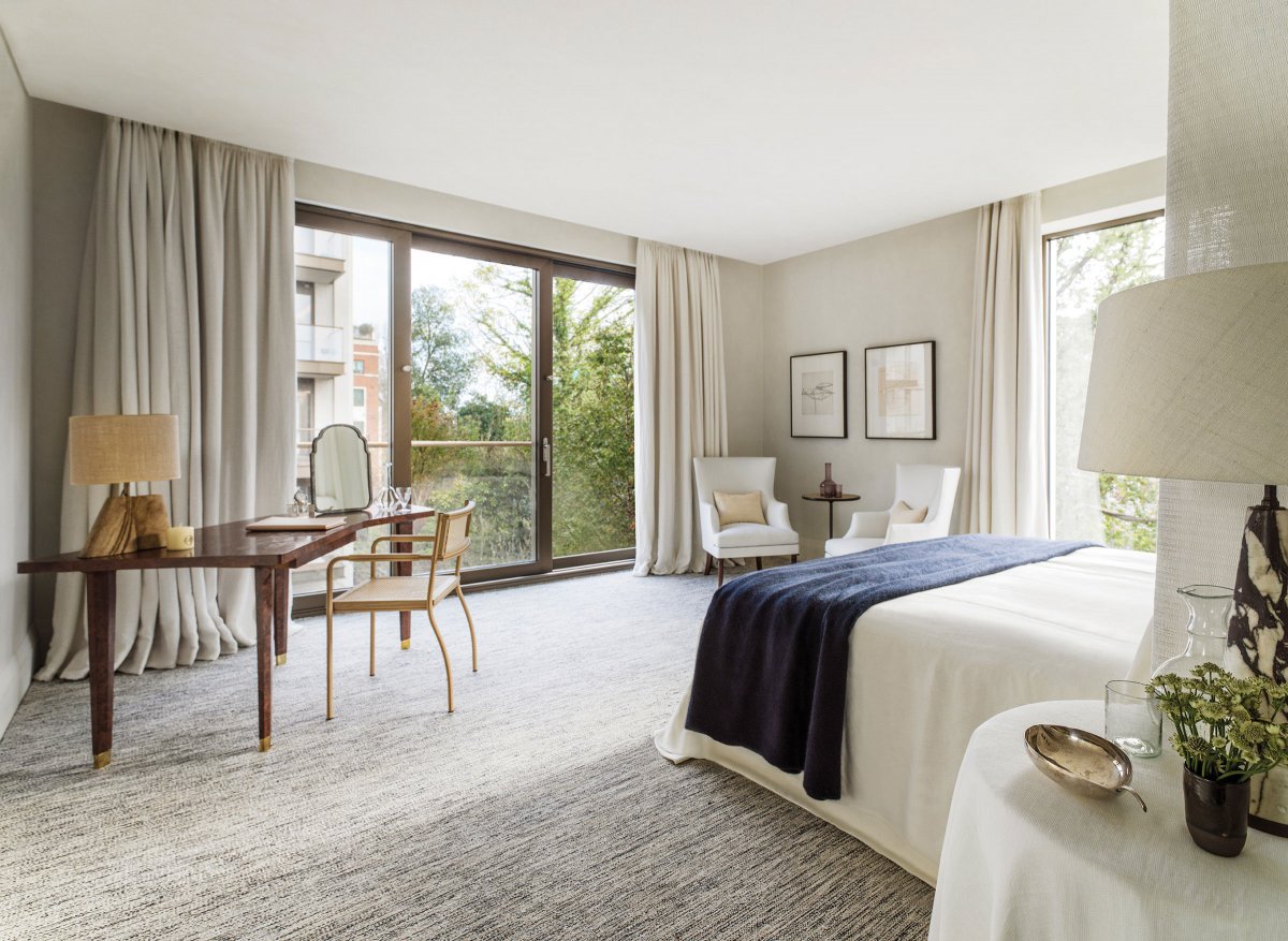 Light-filled master bedroom with full height windows