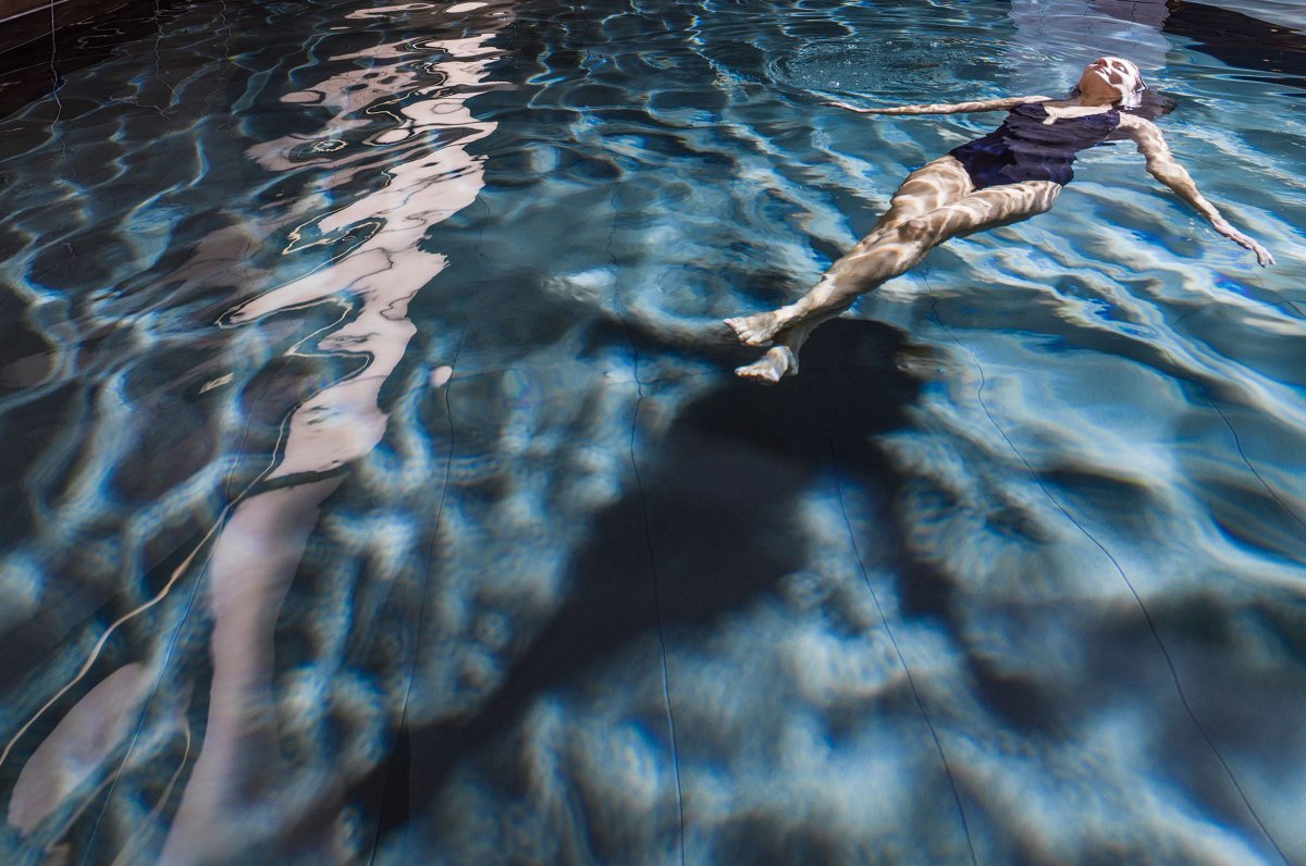 Woman is relaxing in swimming pool 